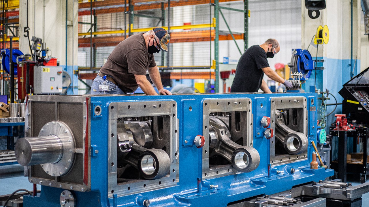 Two Ariel employees assembling an Ariel compressor