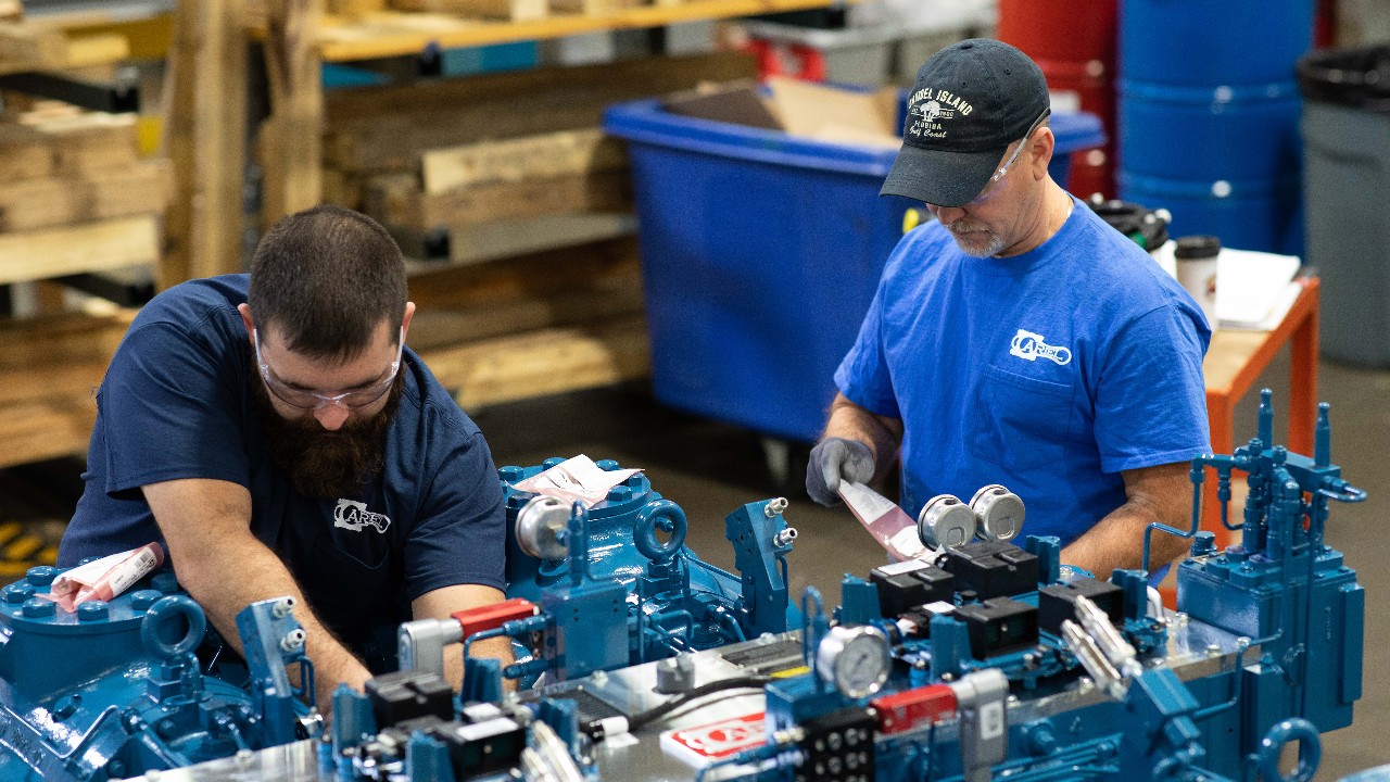 Two assemblers working on an Ariel compressor