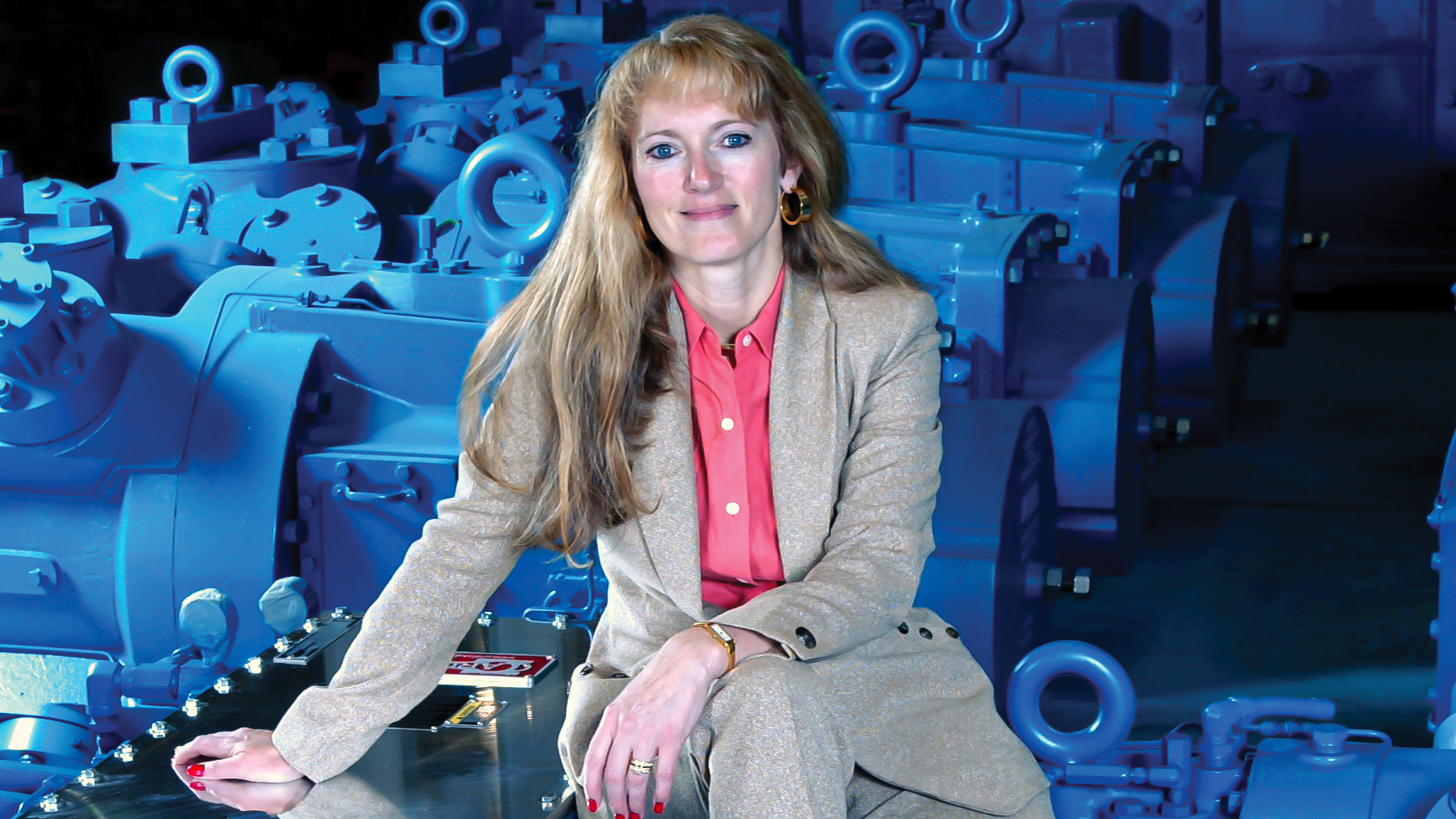 Karen Wright sits next to several compressor cylinders