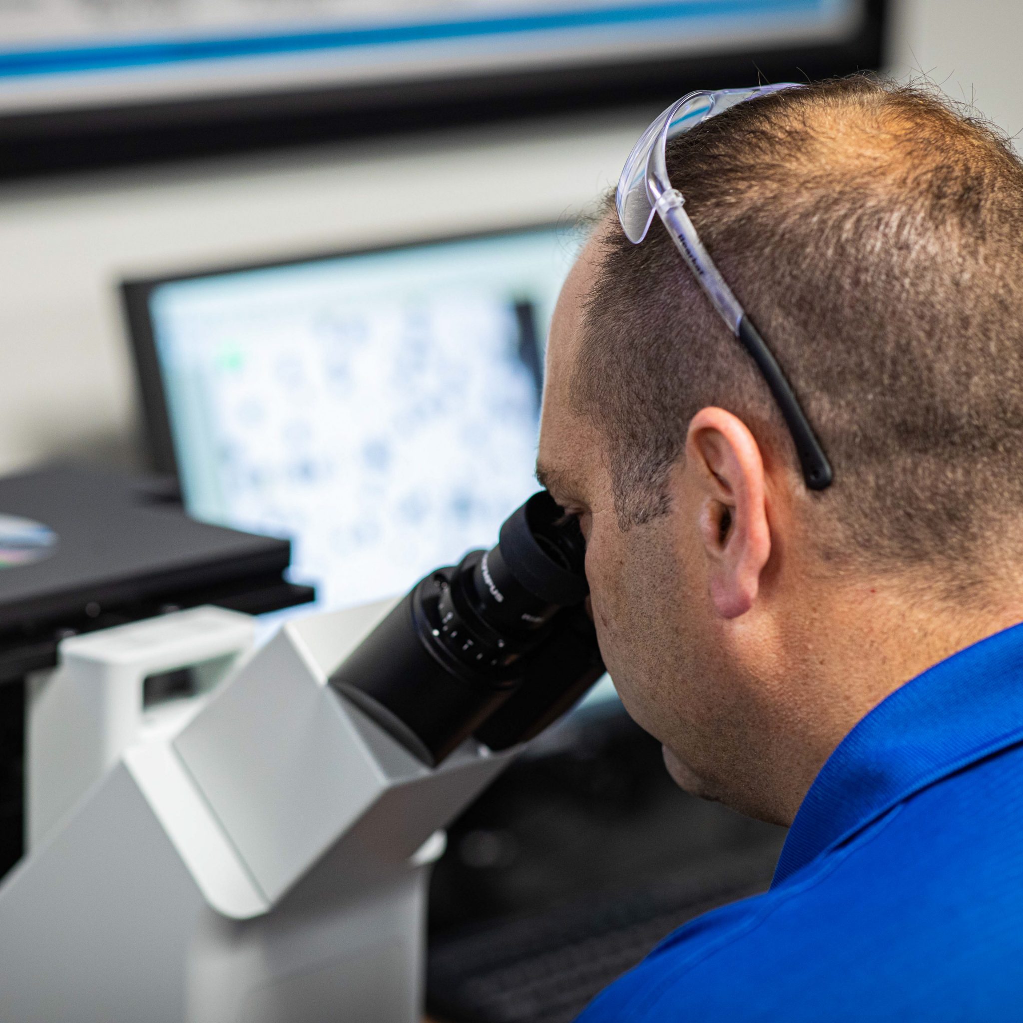 A Quality Inspector uses an inverted microscope to test the quality of metal sample in the Materials Lab