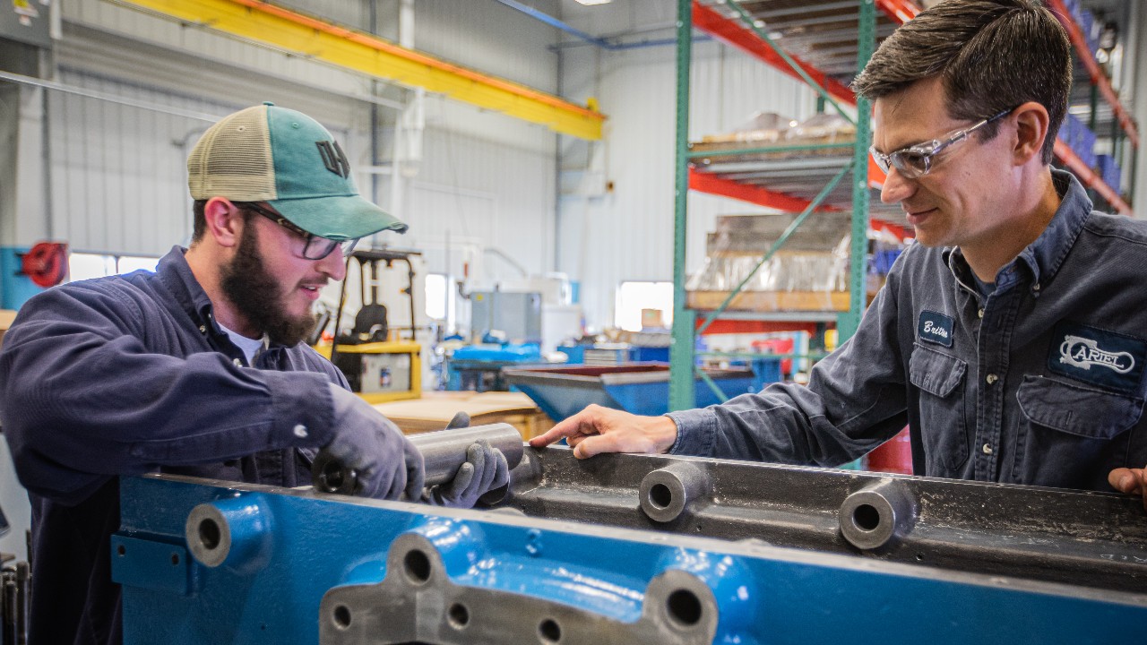 An Engineering Co-op is trained on a compressor frame in the Training Center