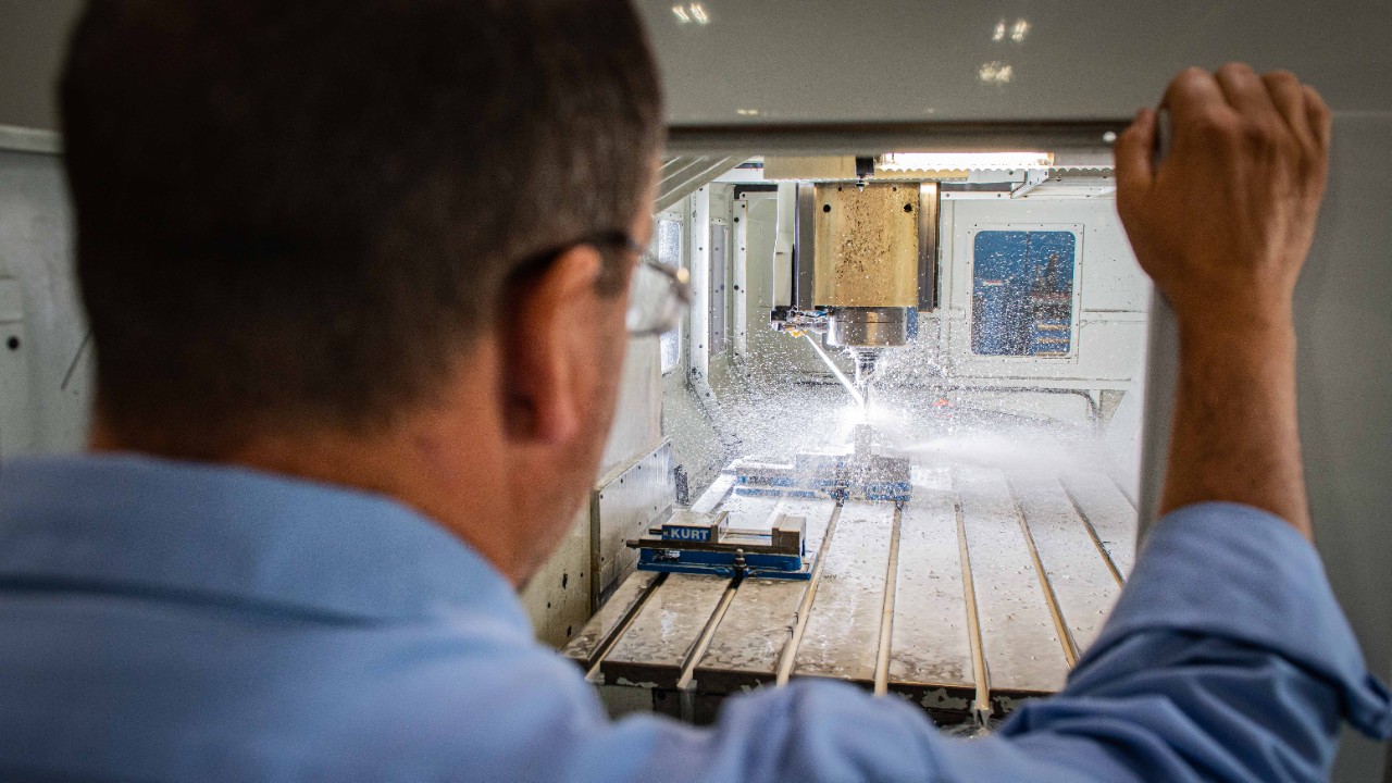 An Ariel machinist observers a part being milled.