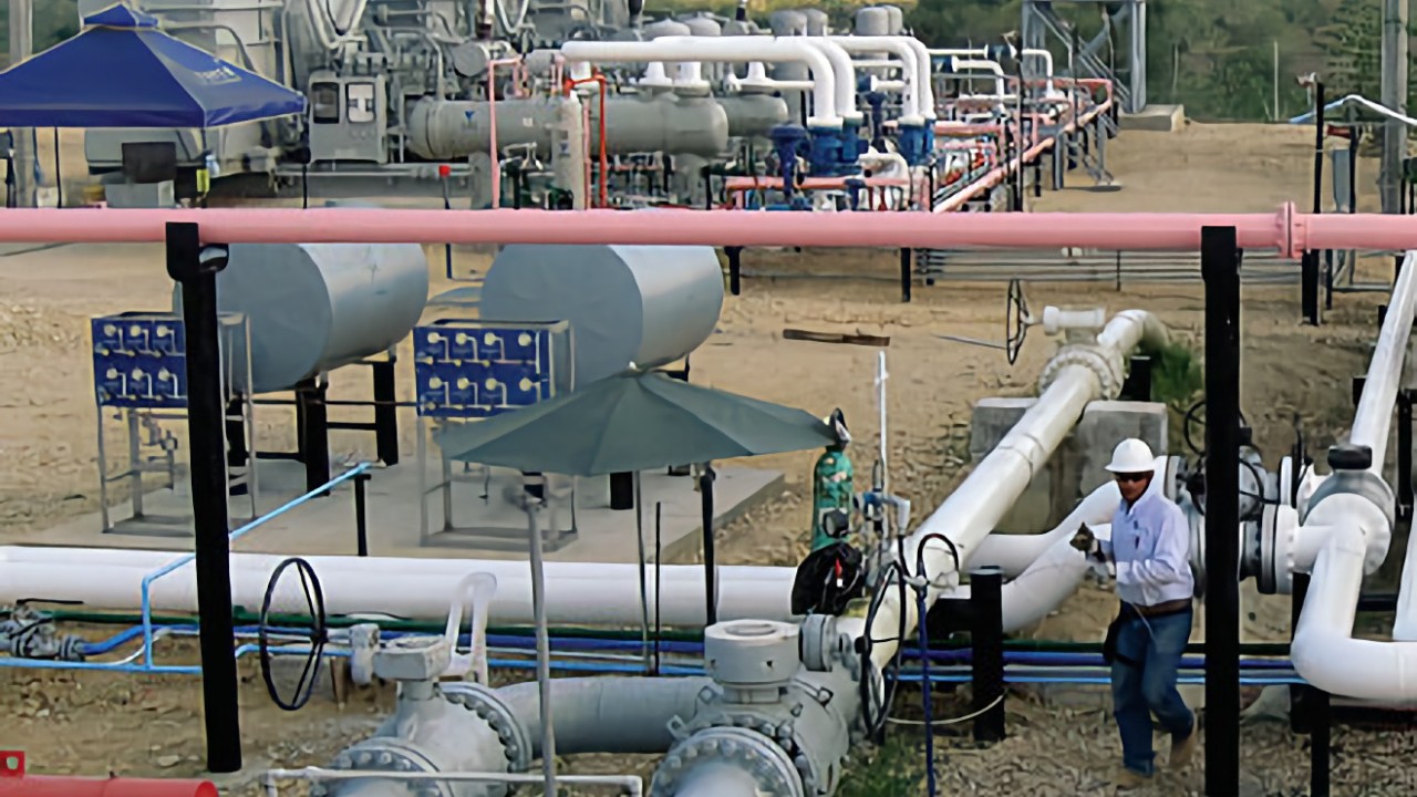 A staff member of Pacifica Rubiales Energy works on a JGE unit at the La Creciente gas field in Colombia