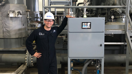 A Sloan worker standing next to an installed Sloan system